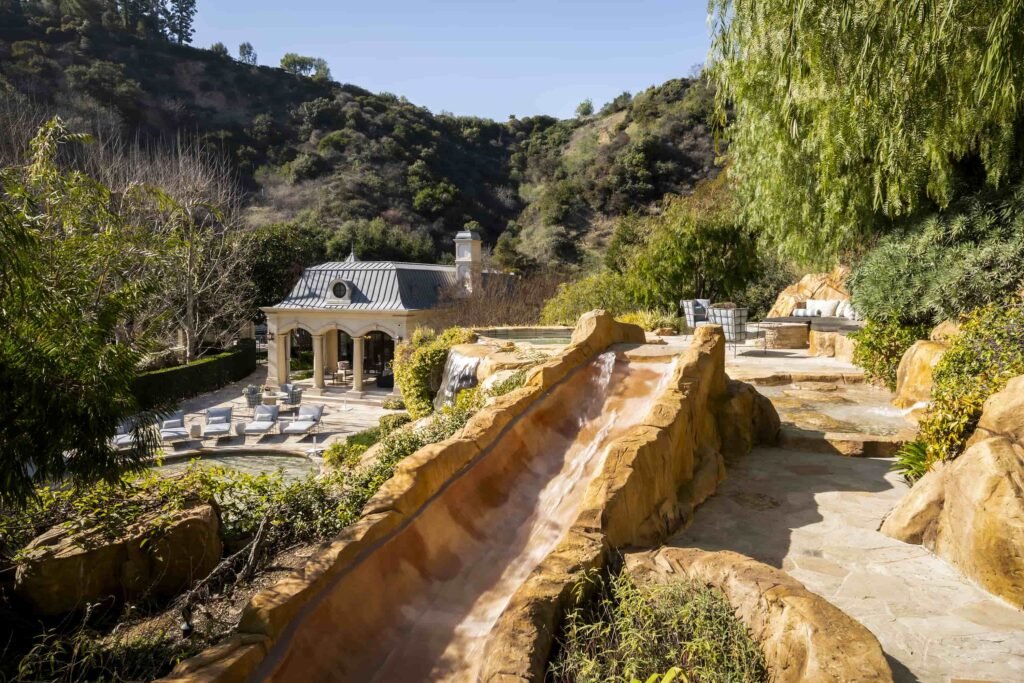 Paris Hilton buys Mark Wahlberg’s \$63m Beverly Park mansion with 12 bedrooms, pro gym, golf course, and top-tier privacy after losing her last home in LA fires.