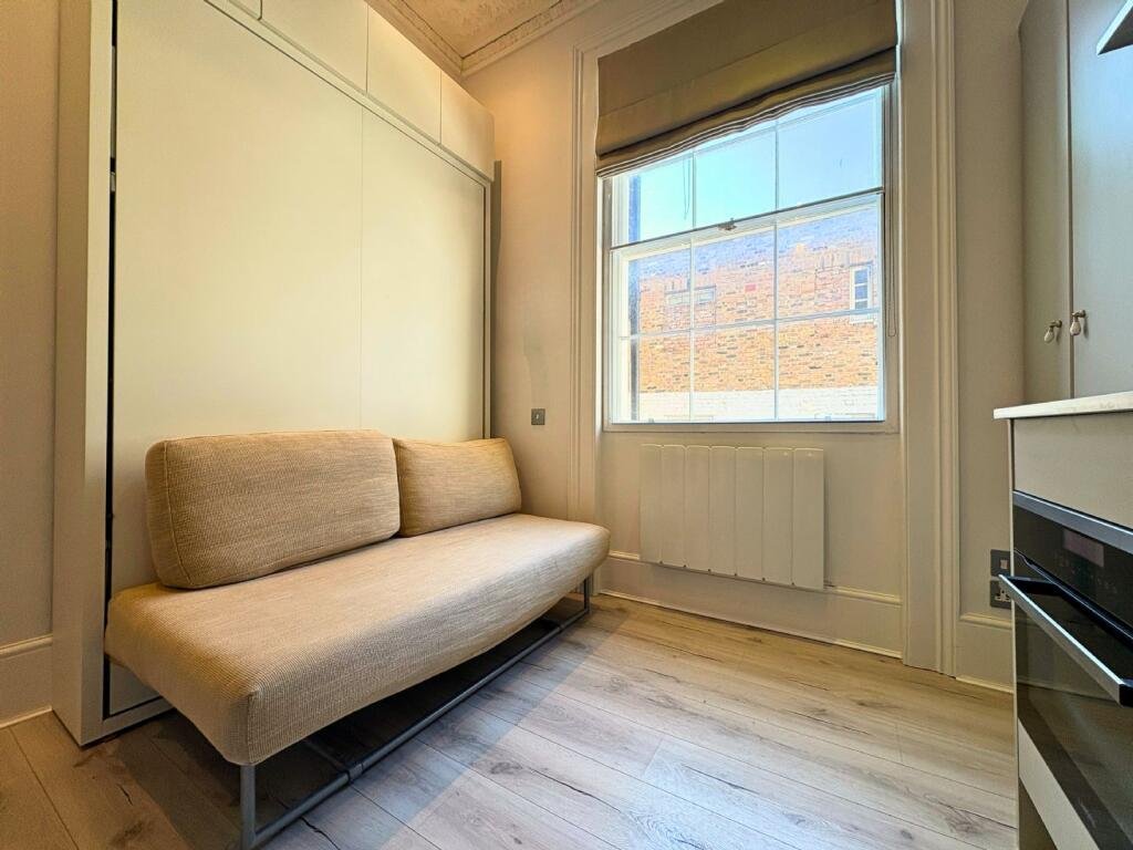 Ingenious fold-away bed and modern shower maximize space in this £1,400 Baker Street studio flat, where you can cook from bed and enjoy bills included for £63 weekly.