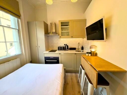 Ingenious fold-away bed and modern shower maximize space in this £1,400 Baker Street studio flat, where you can cook from bed and enjoy bills included for £63 weekly.