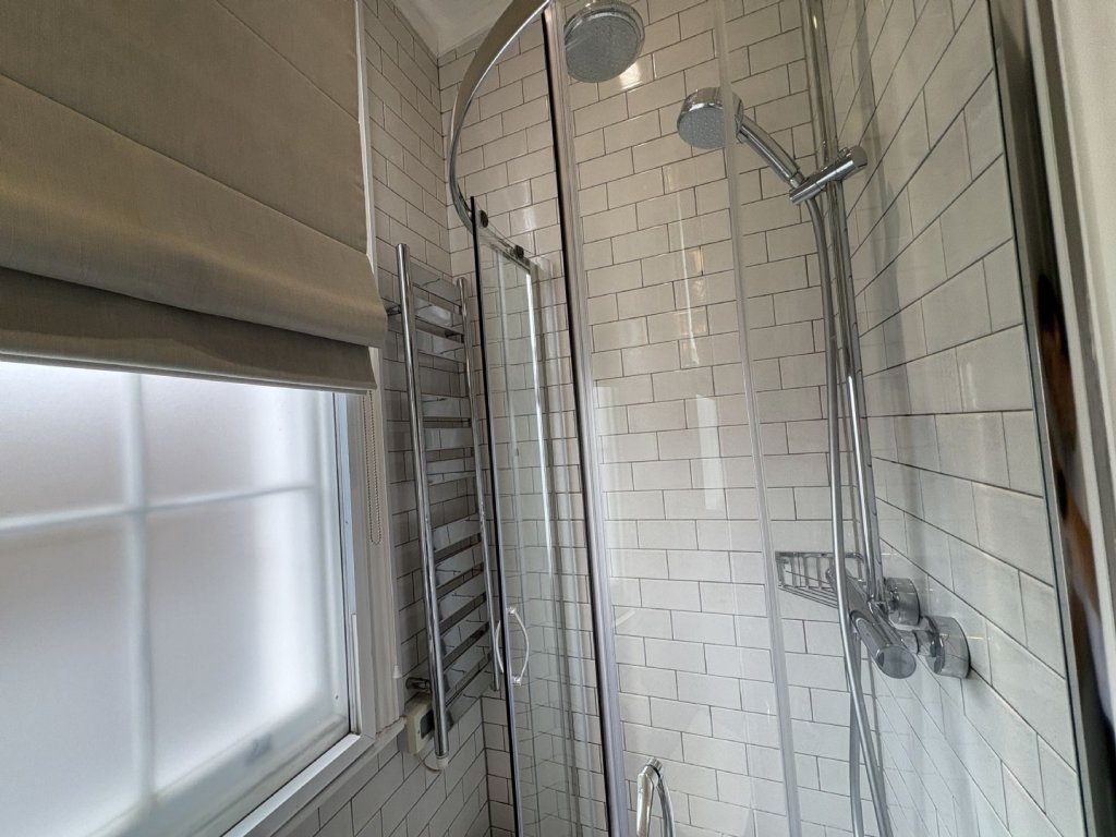 Ingenious fold-away bed and modern shower maximize space in this £1,400 Baker Street studio flat, where you can cook from bed and enjoy bills included for £63 weekly.