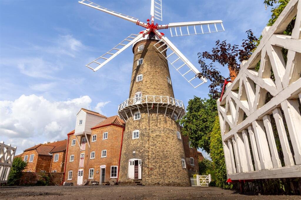 Historic Maud Foster Windmill in Lincolnshire is for sale at £549,950 with a penthouse home, shop, flour mill, and potential for a wedding venue or holiday let.