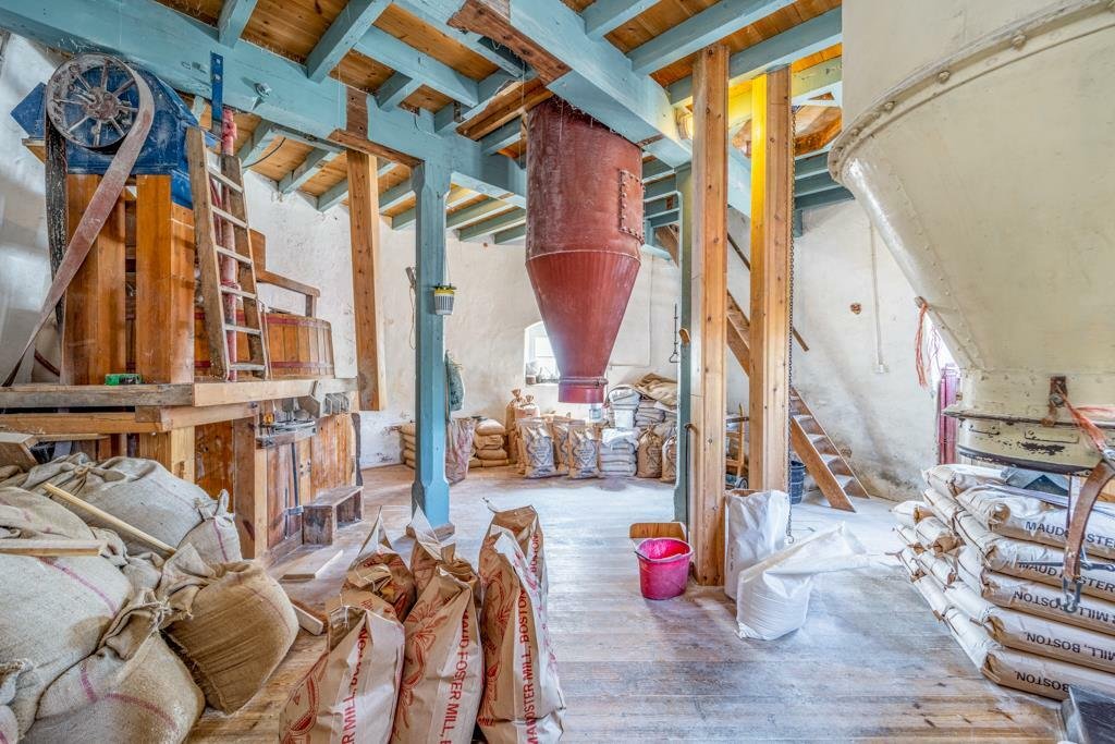 Historic Maud Foster Windmill in Lincolnshire is for sale at £549,950 with a penthouse home, shop, flour mill, and potential for a wedding venue or holiday let.
