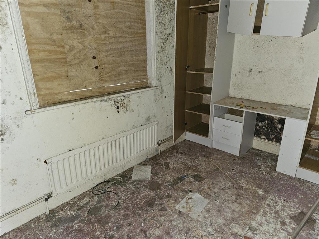 A £450,000 Winchester home with boarded windows, blackened walls and renovation needs is up for auction, with buyers advised to bring a torch and wear sturdy shoes.