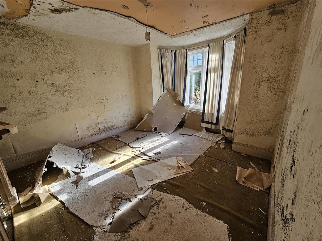 A £450,000 Winchester home with boarded windows, blackened walls and renovation needs is up for auction, with buyers advised to bring a torch and wear sturdy shoes.