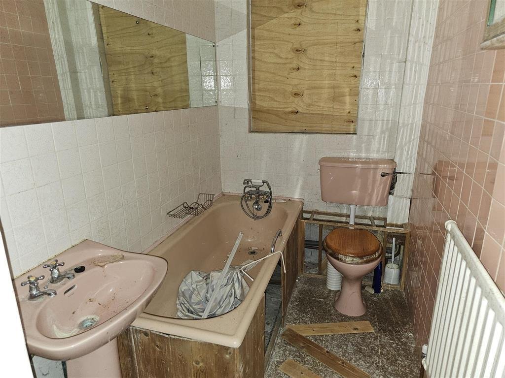 A £450,000 Winchester home with boarded windows, blackened walls and renovation needs is up for auction, with buyers advised to bring a torch and wear sturdy shoes.