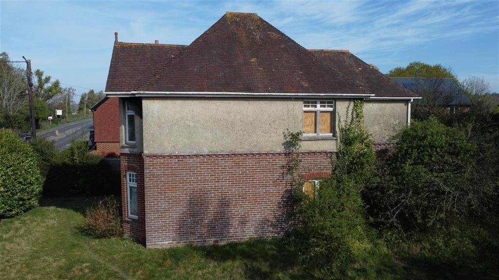 A £450,000 Winchester home with boarded windows, blackened walls and renovation needs is up for auction, with buyers advised to bring a torch and wear sturdy shoes.