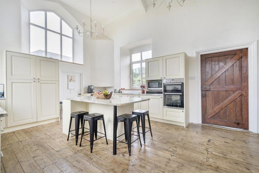 A restored 1876 schoolhouse in Devon with church views and a graveyard garden hits the market for £525,000, offering charm, history, and countryside tranquility.