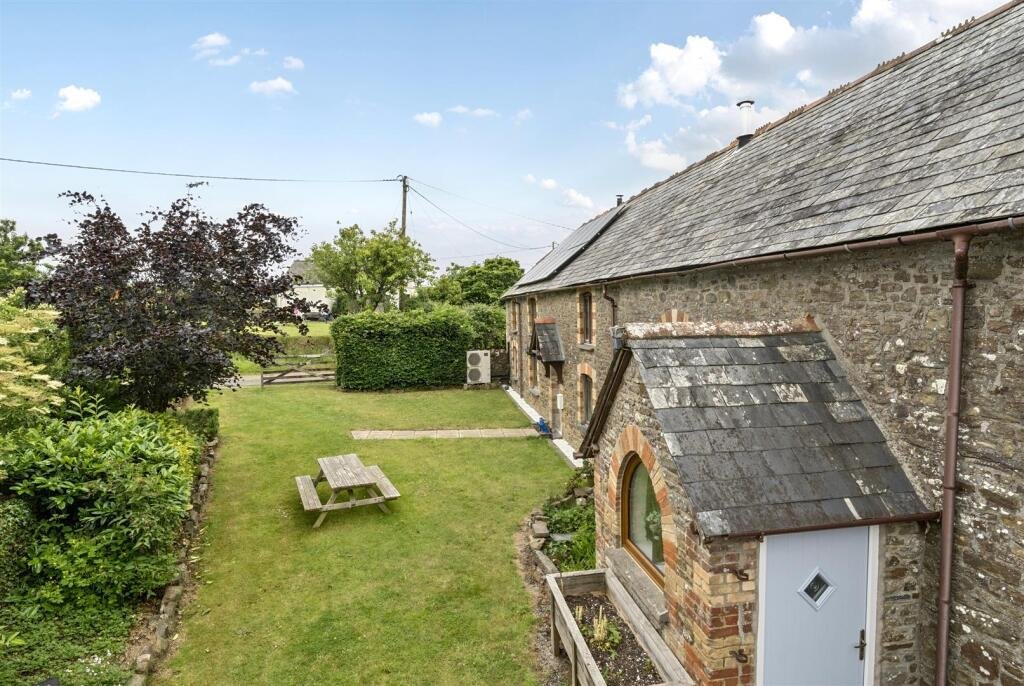A restored 1876 schoolhouse in Devon with church views and a graveyard garden hits the market for £525,000, offering charm, history, and countryside tranquility.