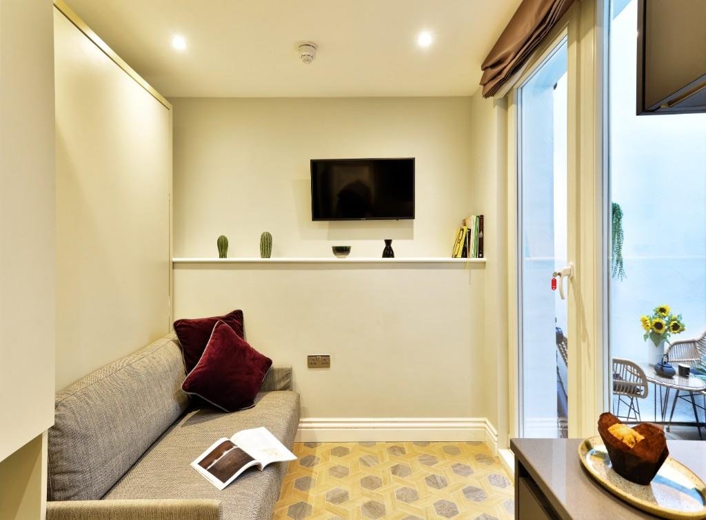 Tiny Marylebone flat with sofa bed, shared kitchen, and compact courtyard costs £2,578 a month, offering luxury service but less space than a house in Shildon.
