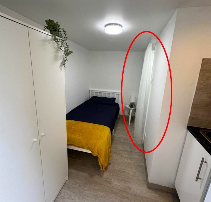 A £750-a-month Canning Town studio with no windows and a curtain for a bathroom door offers minimal space, limited kitchen facilities, and all bills included in rent.