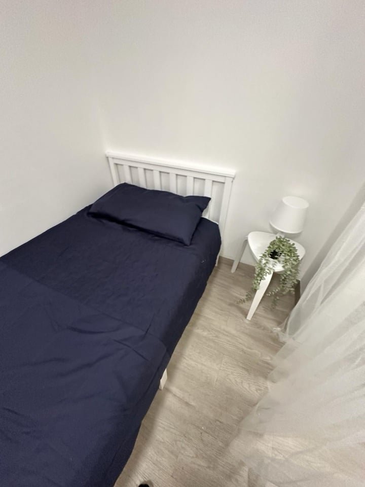 A £750-a-month Canning Town studio with no windows and a curtain for a bathroom door offers minimal space, limited kitchen facilities, and all bills included in rent.