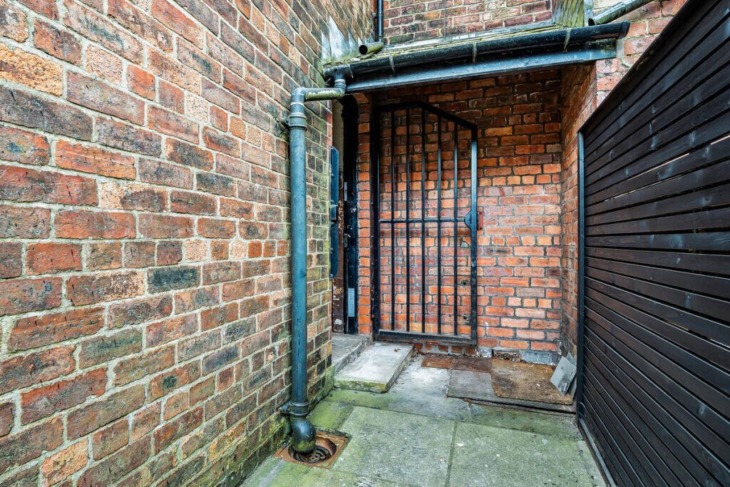 A historic 1887 police station in Marple with its own cell is for sale at £165,000, offering planning approval to convert it into a unique two-bedroom character home.
