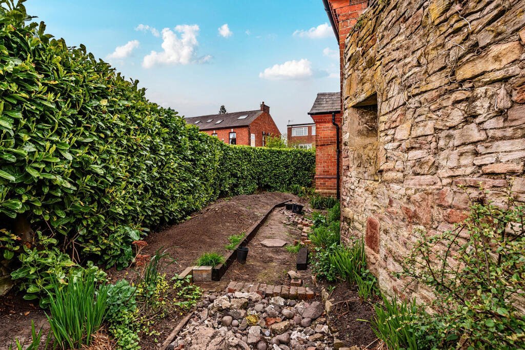 A historic 1887 police station in Marple with its own cell is for sale at £165,000, offering planning approval to convert it into a unique two-bedroom character home.