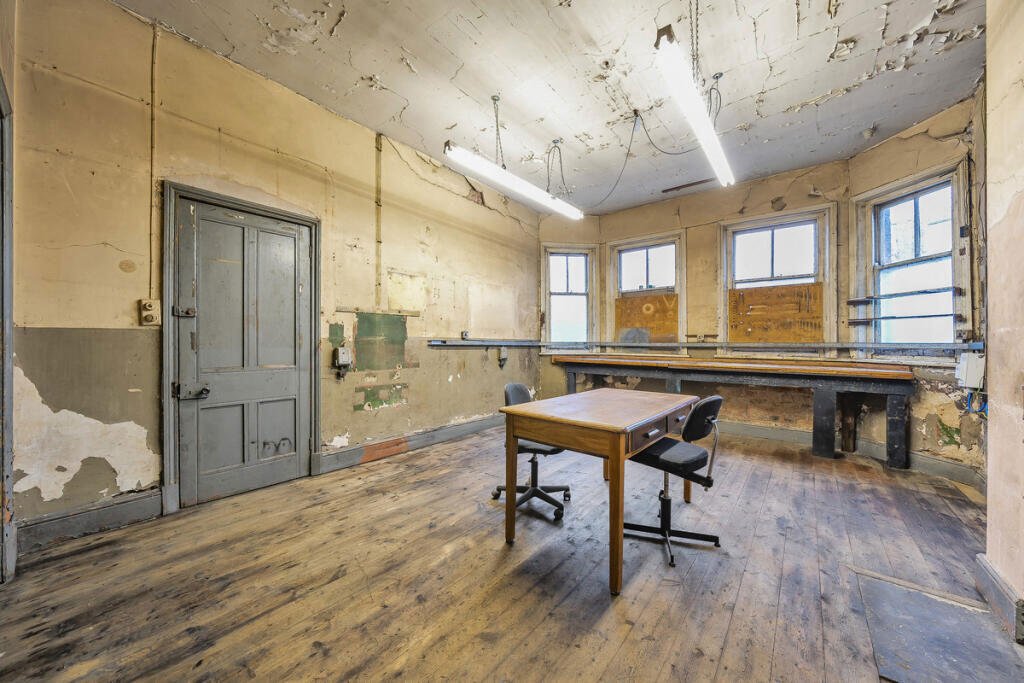 A historic 1887 police station in Marple with its own cell is for sale at £165,000, offering planning approval to convert it into a unique two-bedroom character home.