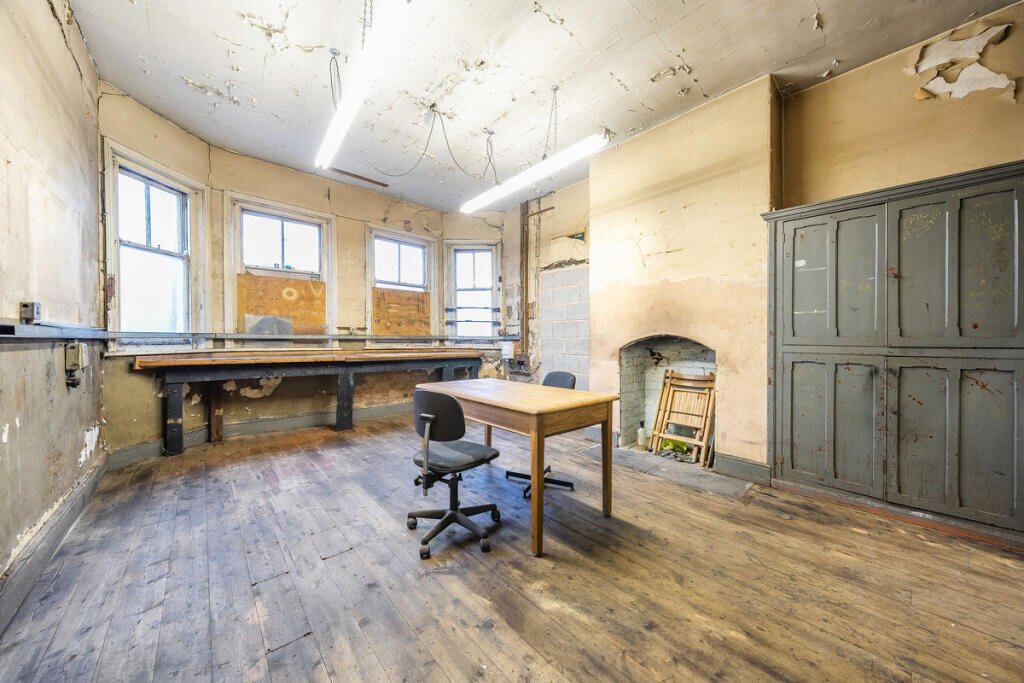 A historic 1887 police station in Marple with its own cell is for sale at £165,000, offering planning approval to convert it into a unique two-bedroom character home.