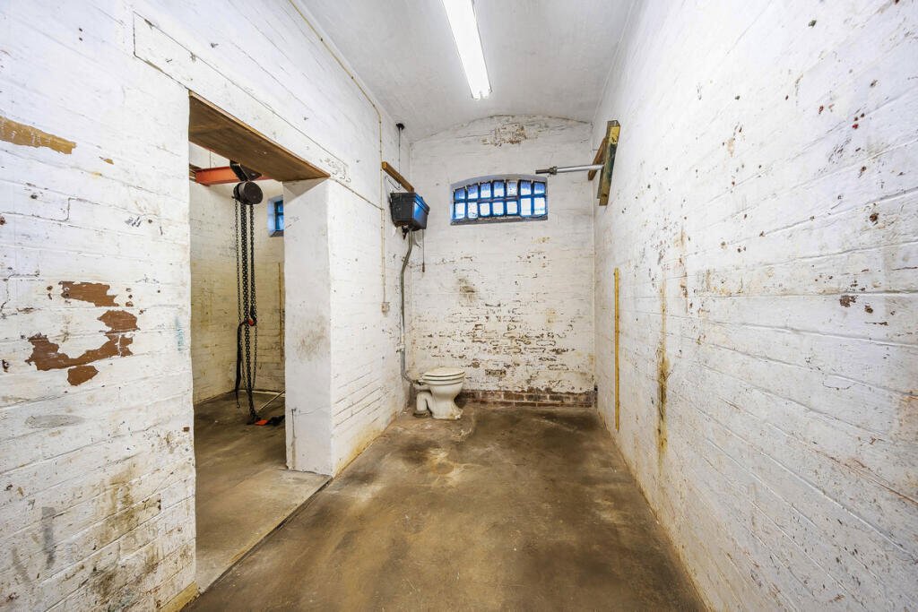 A historic 1887 police station in Marple with its own cell is for sale at £165,000, offering planning approval to convert it into a unique two-bedroom character home.