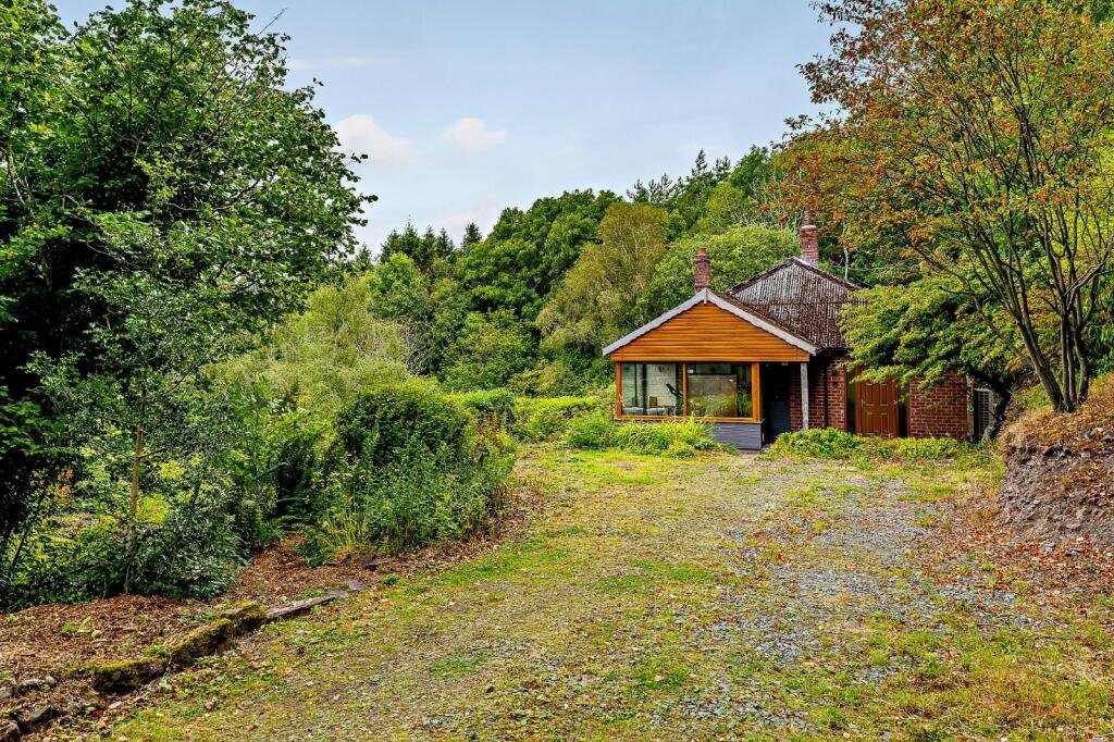 Secluded £520k woodland home in Shrewsbury with two bedrooms nearly one acre of gardens rare plants historic mine features and stunning views offers ultimate privacy.