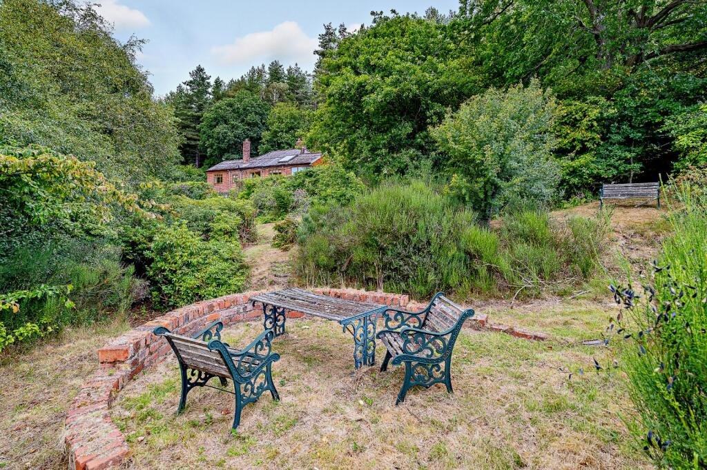Secluded £520k woodland home in Shrewsbury with two bedrooms nearly one acre of gardens rare plants historic mine features and stunning views offers ultimate privacy.