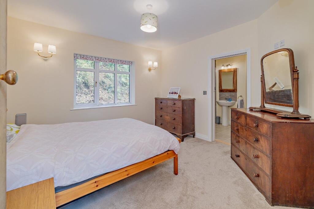 Secluded £520k woodland home in Shrewsbury with two bedrooms nearly one acre of gardens rare plants historic mine features and stunning views offers ultimate privacy.
