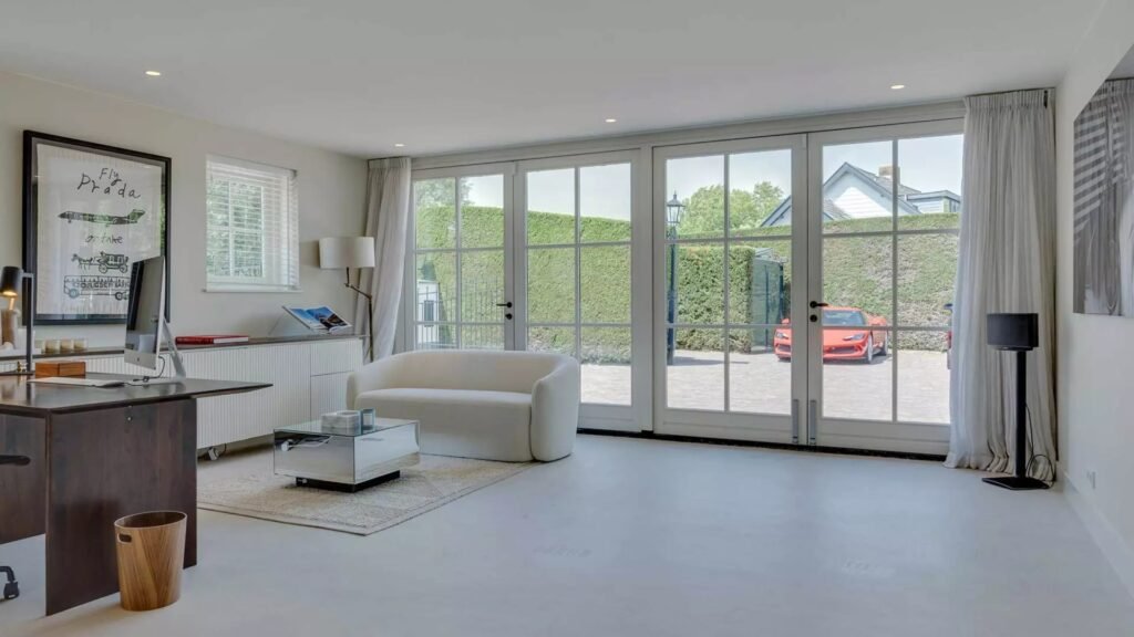 Thatched villa near Amsterdam features luxury interiors, a private boathouse, and a rare home office where you can park two supercars beside your desk.