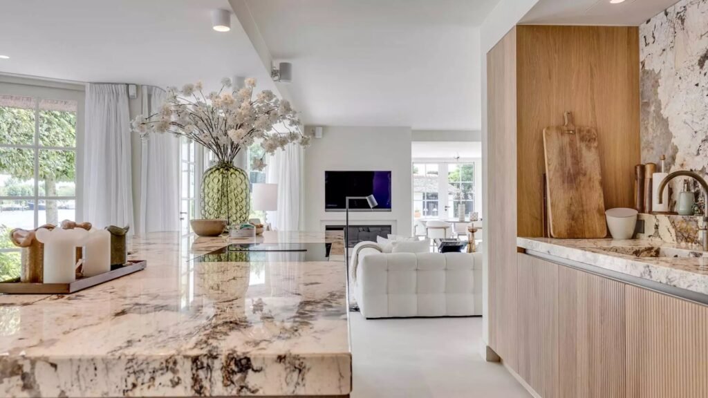 Thatched villa near Amsterdam features luxury interiors, a private boathouse, and a rare home office where you can park two supercars beside your desk.