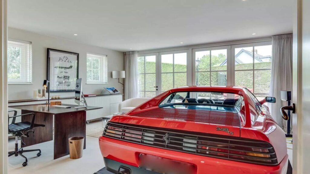 Thatched villa near Amsterdam features luxury interiors, a private boathouse, and a rare home office where you can park two supercars beside your desk.
