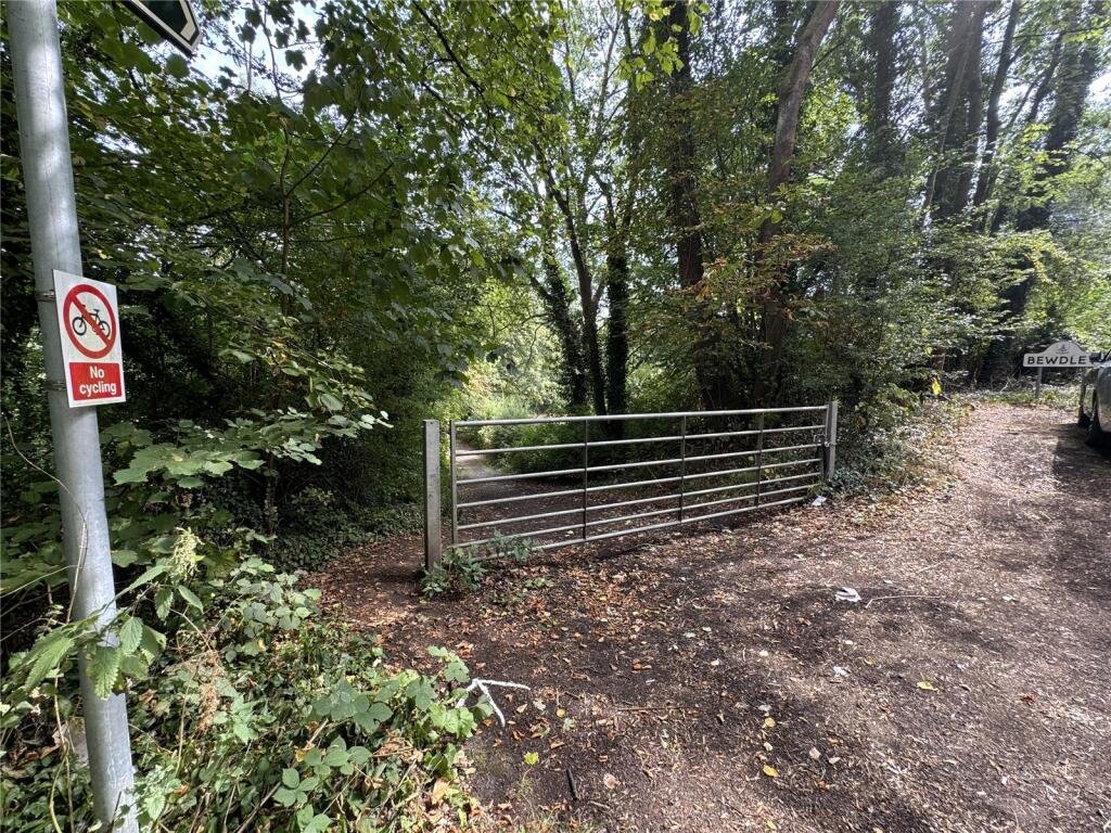 Derelict Bewdley schoolhouse with no roof listed for £40,000. The overgrown triangular plot, once staff housing, is up for auction and accessed only by bridle path.
