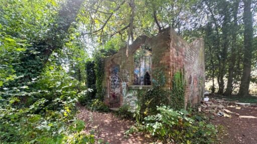 Derelict Bewdley schoolhouse with no roof listed for £40,000. The overgrown triangular plot, once staff housing, is up for auction and accessed only by bridle path.