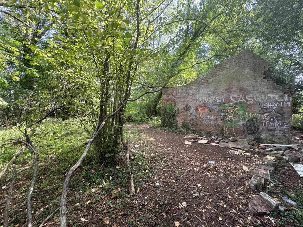 Derelict Bewdley schoolhouse with no roof listed for £40,000. The overgrown triangular plot, once staff housing, is up for auction and accessed only by bridle path.