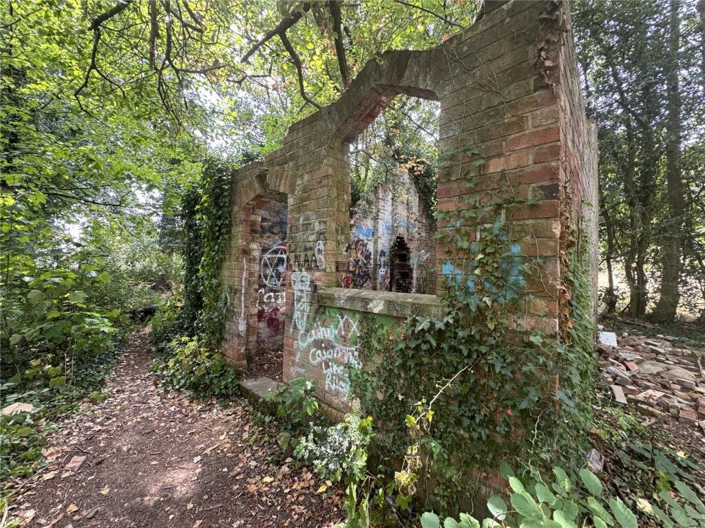 Derelict Bewdley schoolhouse with no roof listed for £40,000. The overgrown triangular plot, once staff housing, is up for auction and accessed only by bridle path.
