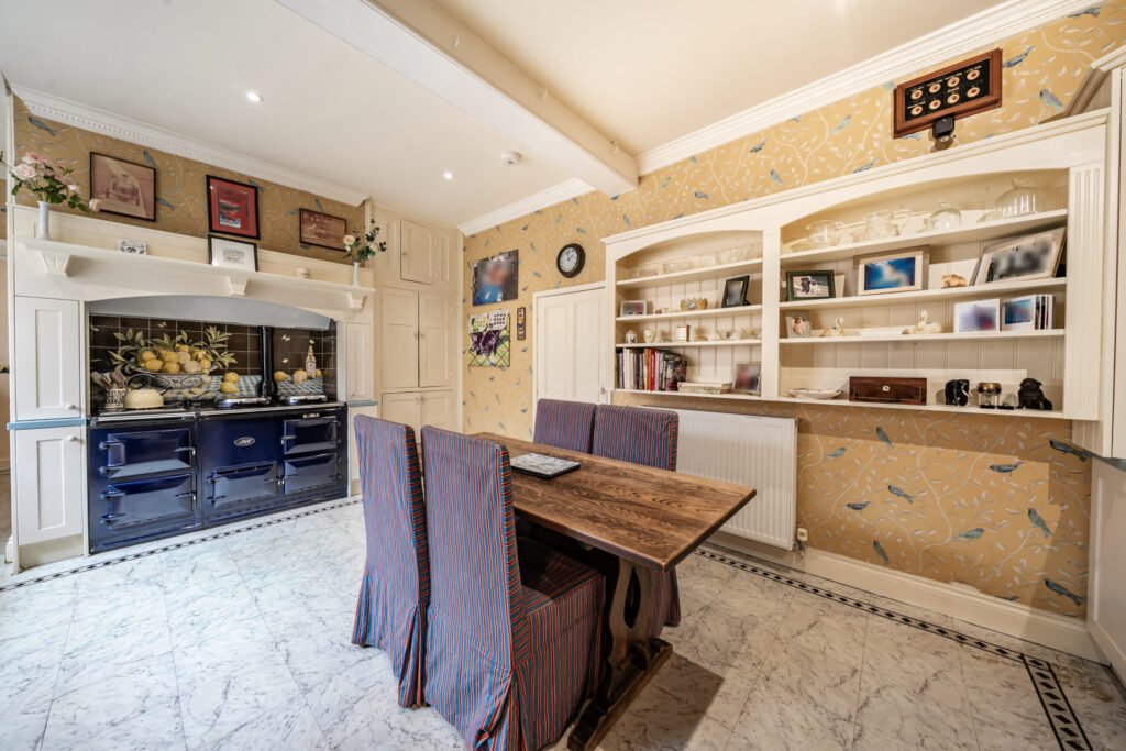 The former Georgian home of Formula One boss Colin Crabbe is for sale at £800,000 featuring elegant period details, annex suites, a walled garden and a swim spa.