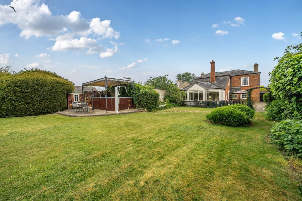 The former Georgian home of Formula One boss Colin Crabbe is for sale at £800,000 featuring elegant period details, annex suites, a walled garden and a swim spa.