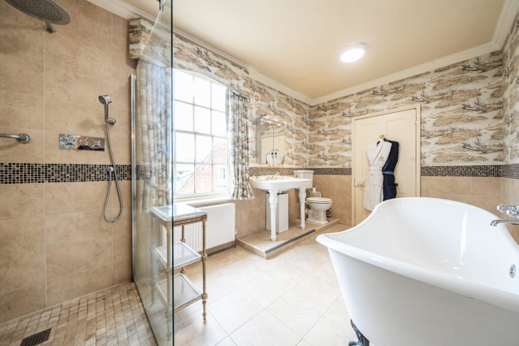 The former Georgian home of Formula One boss Colin Crabbe is for sale at £800,000 featuring elegant period details, annex suites, a walled garden and a swim spa.