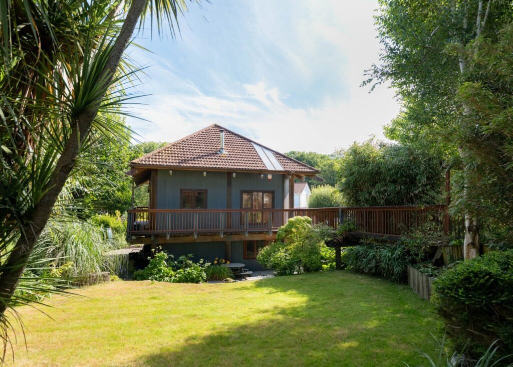 Kate Winslet’s former Japanese-style Pole House in Cornwall is for sale at £600,000, featuring unique stilt design, vaulted ceilings, gardens and coastal charm.