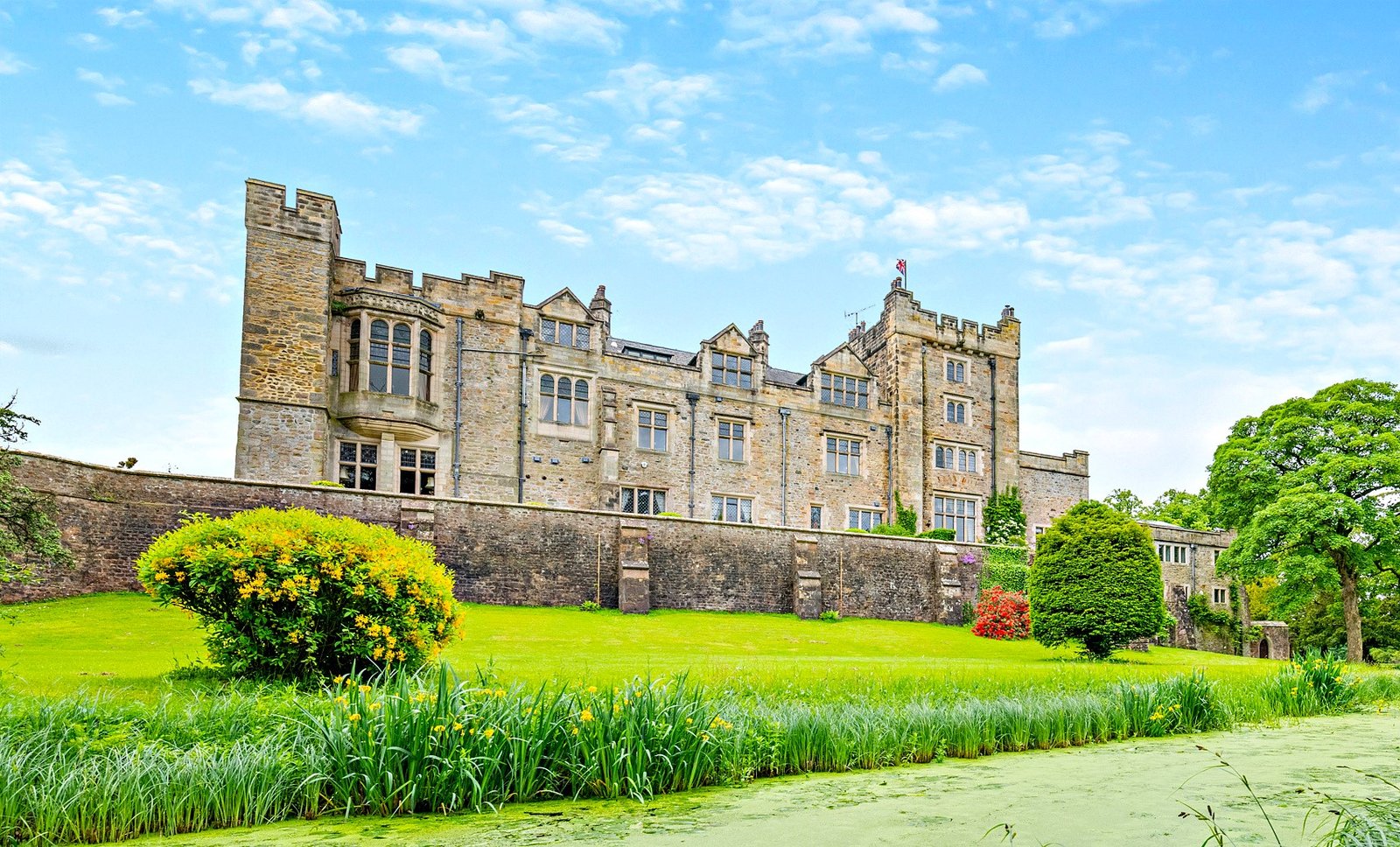A £900,000 wing of historic Thurland Castle offers four beds, medieval features, cinema, tennis court, wine cellar, and landscaped gardens between the Lakes and Dales.