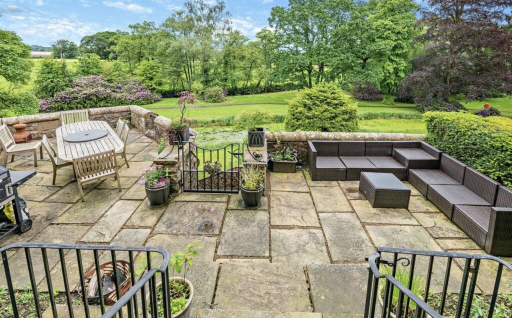 A £900,000 wing of historic Thurland Castle offers four beds, medieval features, cinema, tennis court, wine cellar, and landscaped gardens between the Lakes and Dales.