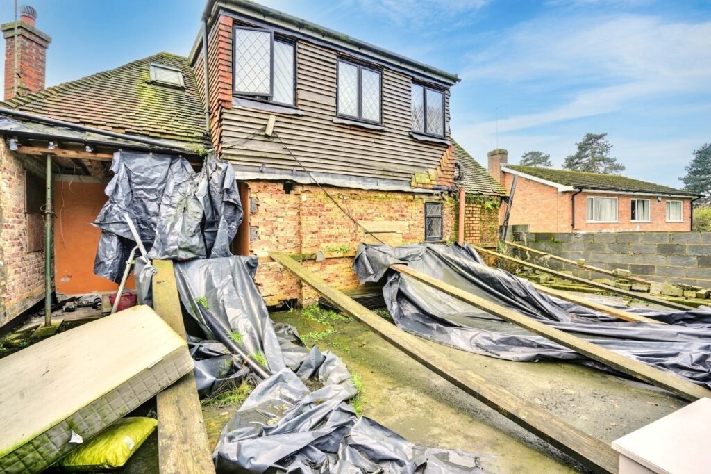 Mould-ridden four-bedroom house in Maidstone priced at £575k offers a risky renovation project with missing windows, rotting ceilings and a drained pool for investors.