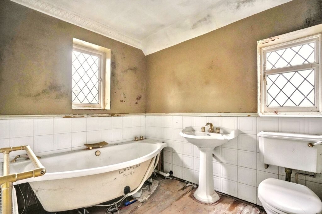 Mould-ridden four-bedroom house in Maidstone priced at £575k offers a risky renovation project with missing windows, rotting ceilings and a drained pool for investors.