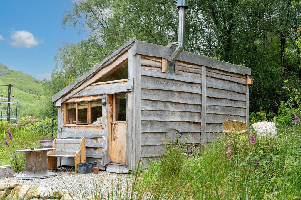 Three quirky eco cabins in Glenfinnan near the Harry Potter viaduct are for sale at £290,000 featuring handcrafted design, scenic views and a shared Swedish style outdoor bath.