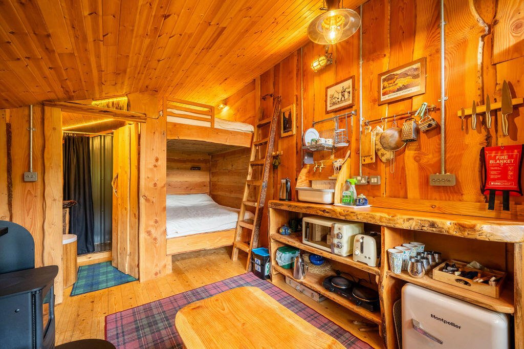 Three quirky eco cabins in Glenfinnan near the Harry Potter viaduct are for sale at £290,000 featuring handcrafted design, scenic views and a shared Swedish style outdoor bath.