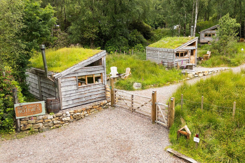 Three quirky eco cabins in Glenfinnan near the Harry Potter viaduct are for sale at £290,000 featuring handcrafted design, scenic views and a shared Swedish style outdoor bath.
