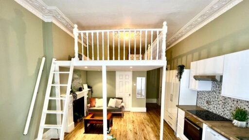 Charming Notting Hill studio with ornate ceiling, mock fireplace and mezzanine bedroom rents for £1,520 a month but comes with limited headroom and quirky layout.