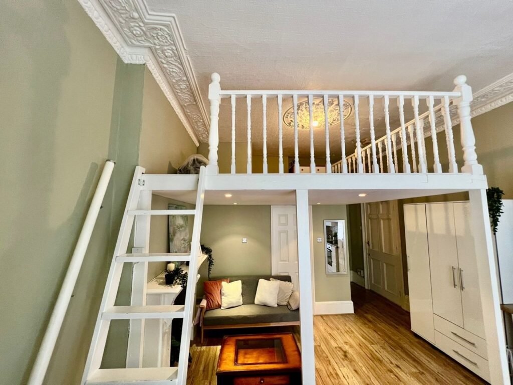 Charming Notting Hill studio with ornate ceiling, mock fireplace and mezzanine bedroom rents for £1,520 a month but comes with limited headroom and quirky layout.
