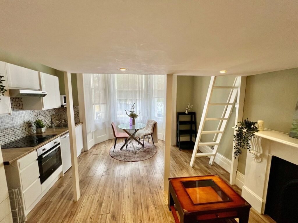 Charming Notting Hill studio with ornate ceiling, mock fireplace and mezzanine bedroom rents for £1,520 a month but comes with limited headroom and quirky layout.