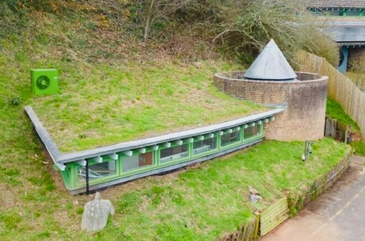 A quirky Hobbit style home in Crediton built into a hillside is on sale for £235,000 offering a unique design, planning permission and a rare development opportunity.
