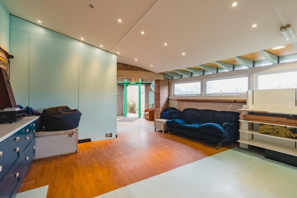 A quirky Hobbit style home in Crediton built into a hillside is on sale for £235,000 offering a unique design, planning permission and a rare development opportunity.