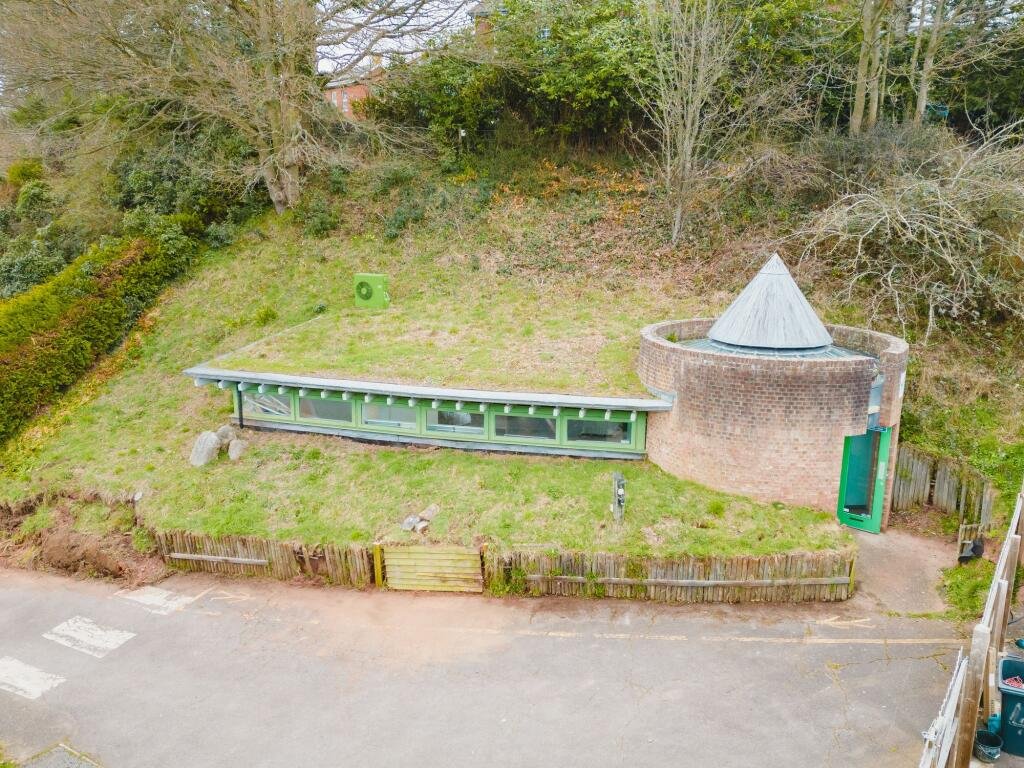 A quirky Hobbit style home in Crediton built into a hillside is on sale for £235,000 offering a unique design, planning permission and a rare development opportunity.