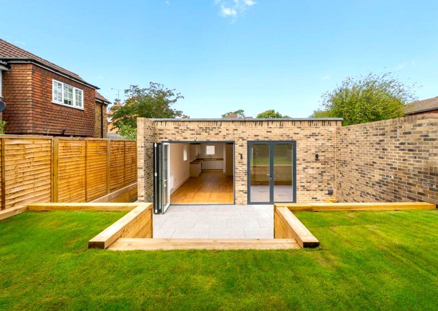 A tiny one bedroom brick cabin in Effingham is on sale for £475k, over £200k above the UK average, offering modern design, a private garden and eco friendly features.