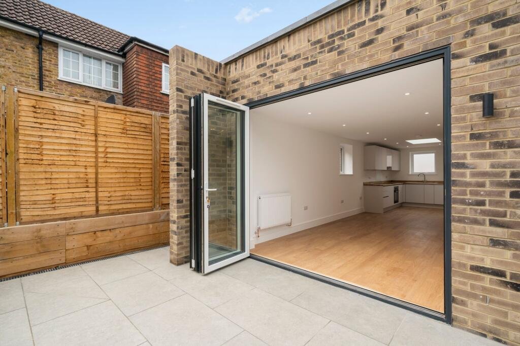 A tiny one bedroom brick cabin in Effingham is on sale for £475k, over £200k above the UK average, offering modern design, a private garden and eco friendly features.