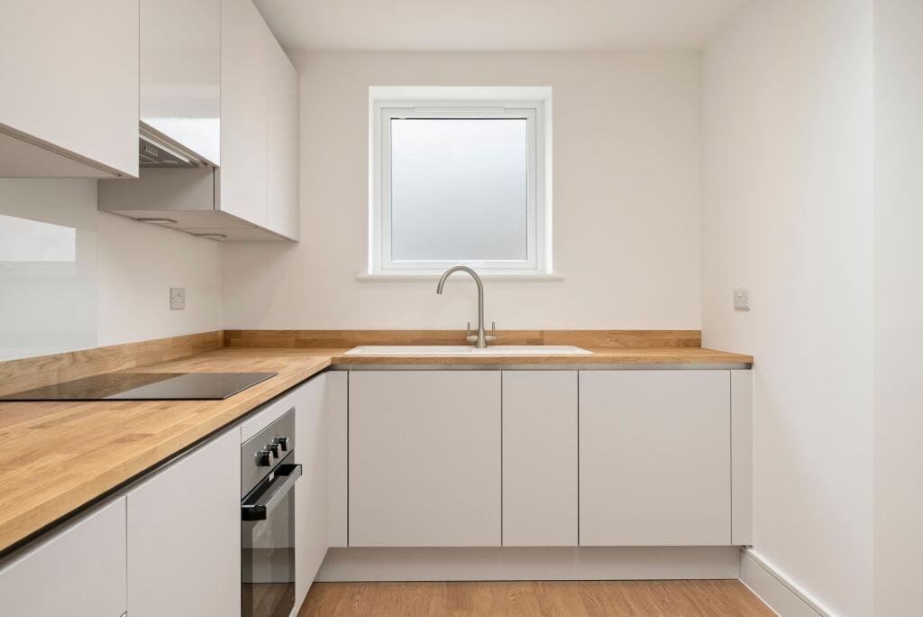 A tiny one bedroom brick cabin in Effingham is on sale for £475k, over £200k above the UK average, offering modern design, a private garden and eco friendly features.